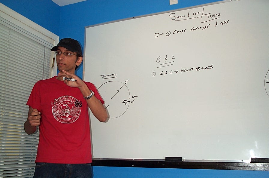 Instructor Student Mayank Mittal conducting pre-flight ground instruction.  Langley Flying School. 